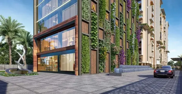 Elegant Atmos entrance with green facade, sculpture and water feature